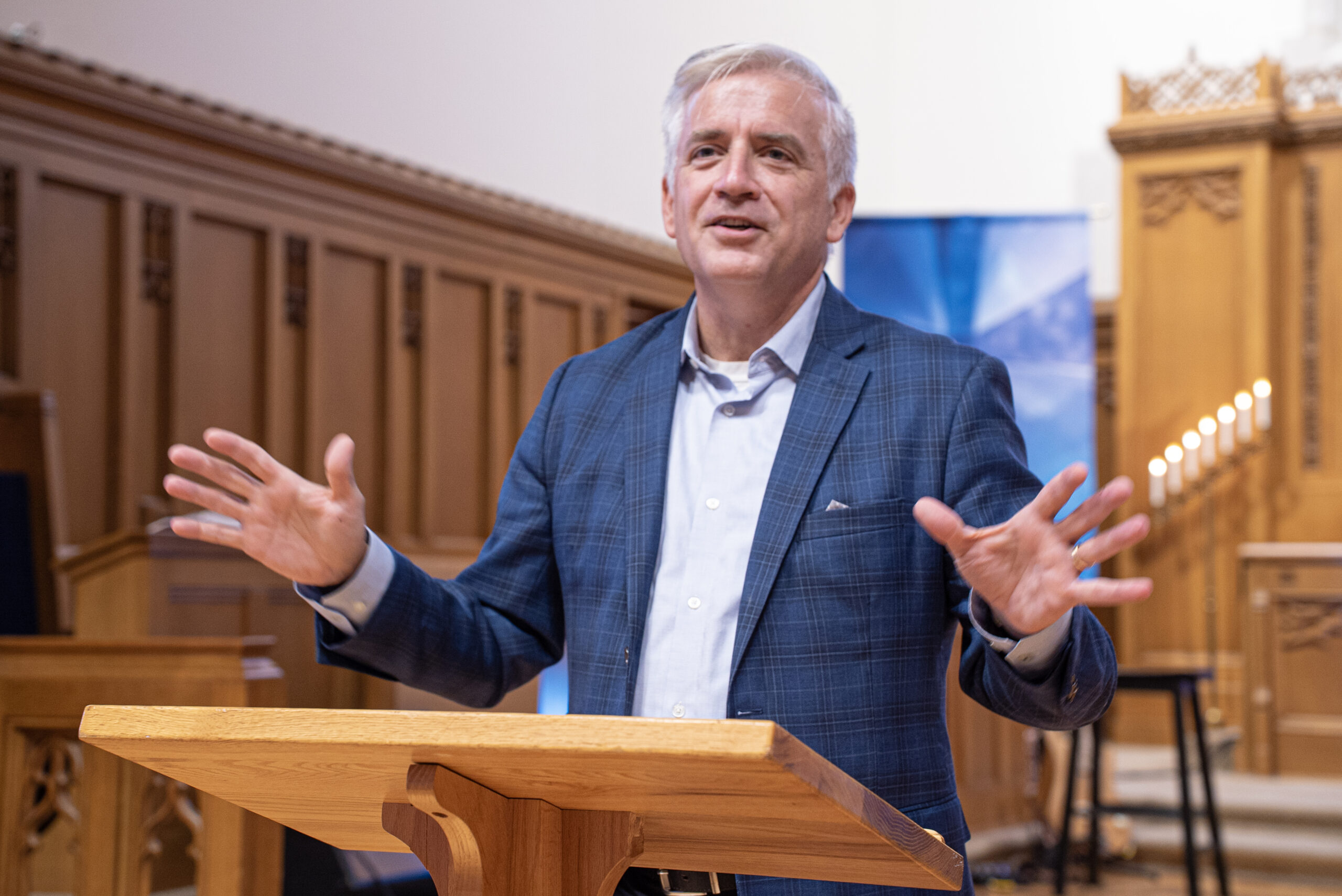 Spencer preaching a sermon from the pulpit; watch online or in person